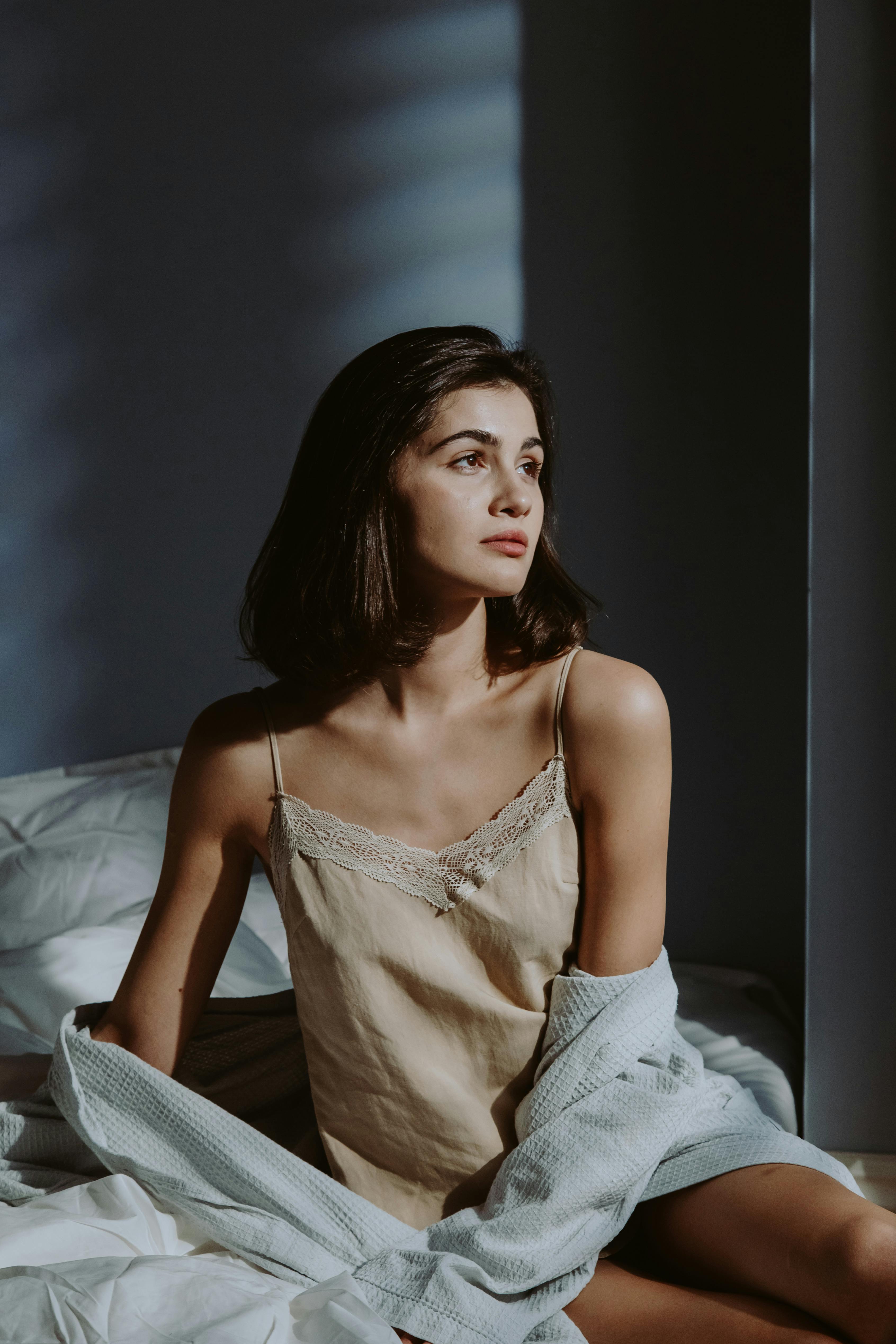 Photo of a Woman in Sleepwear Clothes Looking Away · Free Stock Photo