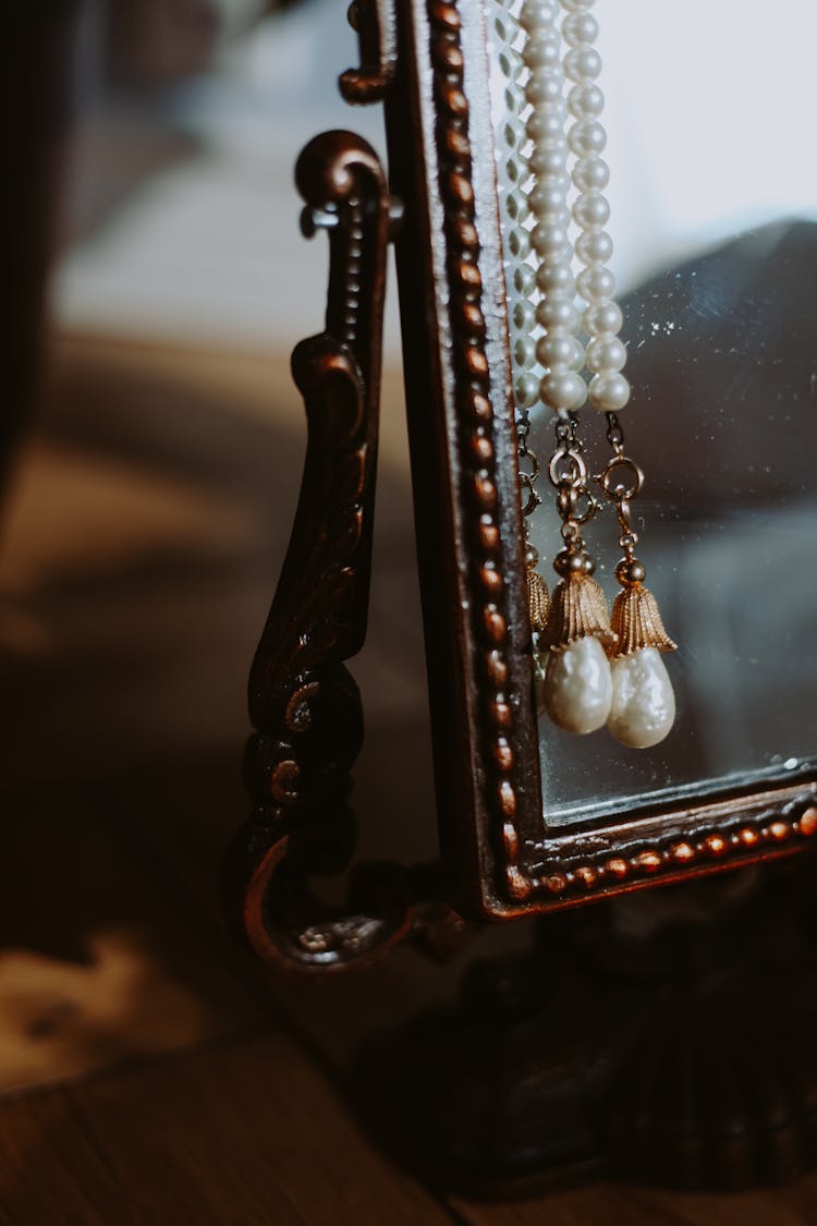 Pearl Necklace On Metal Framed Mirror