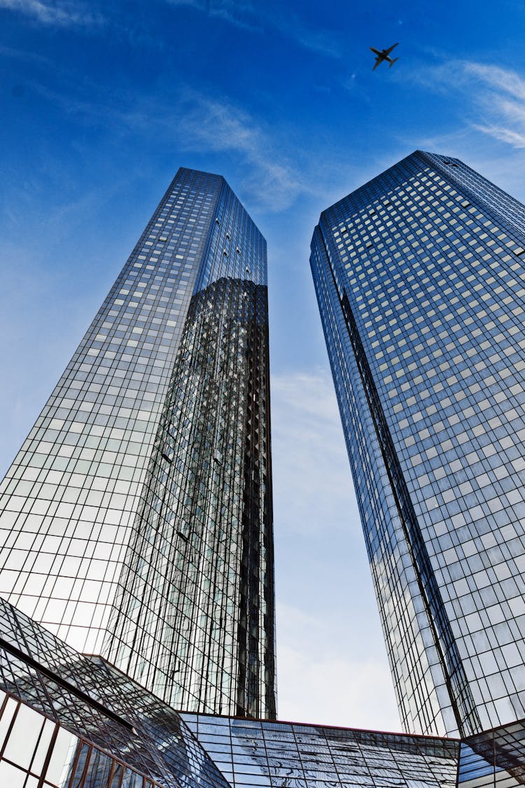 An Airplane Flying Above Deutsche Bank Twin Towers