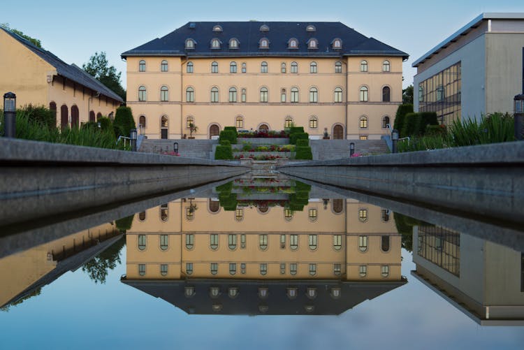 Pond In Garden Near Buildings