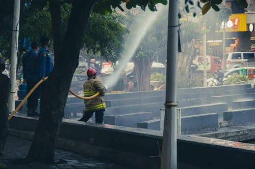 Free A Firefighter Holding a Fire Hose Stock Photo