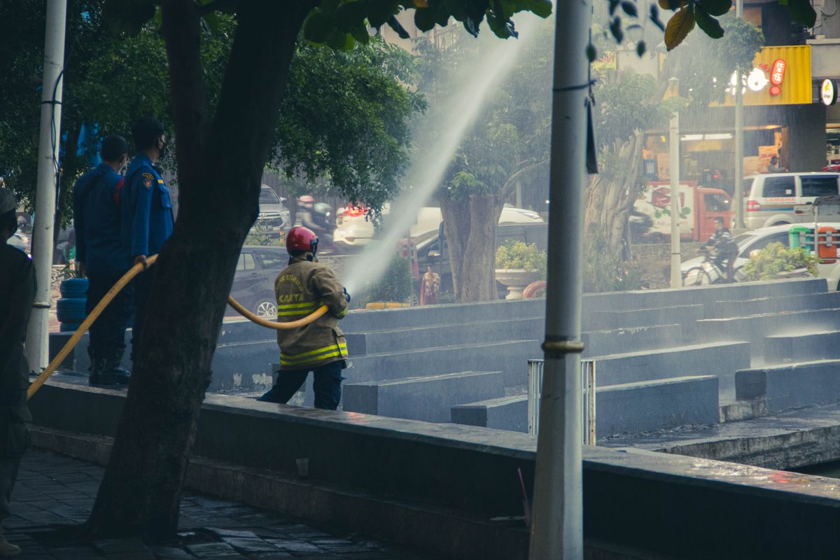 Firefighters working with a fire hose during emergency response