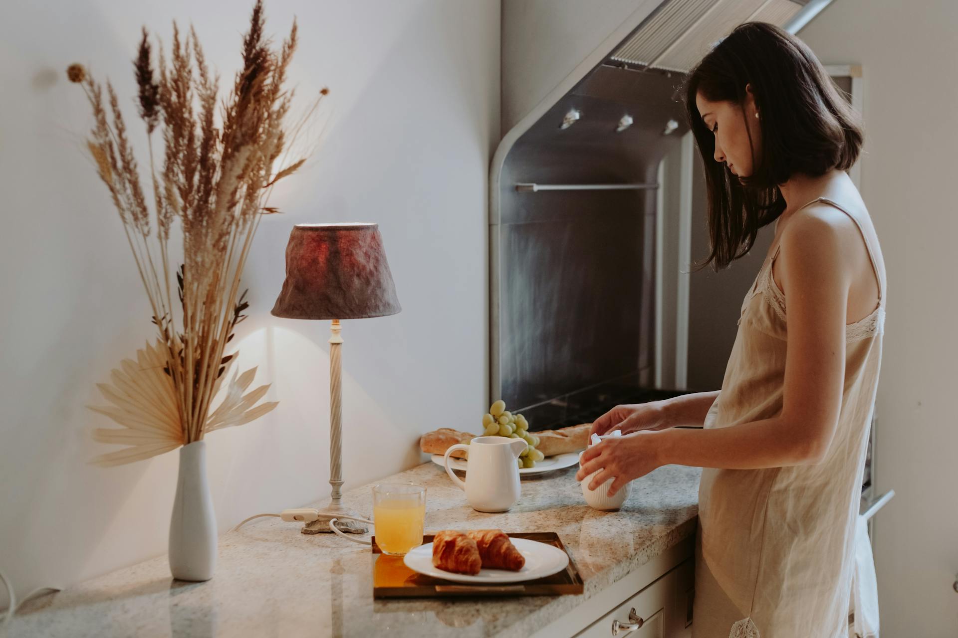 Woman in Nightdress Standing Beside Kitchen Counter