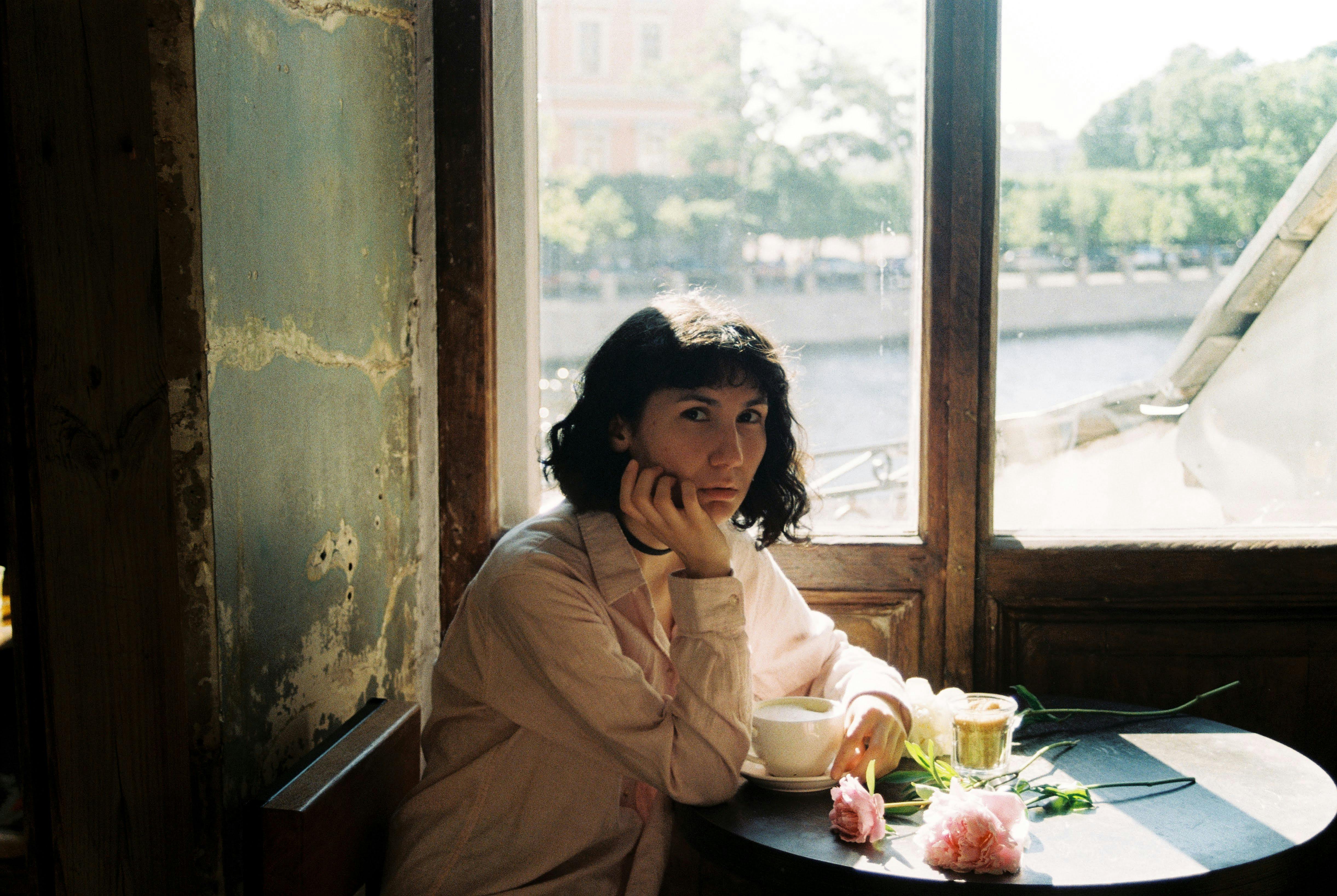 woman sitting by cafe table