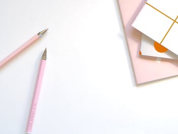 Two Pink Ballpoint Pens on Table