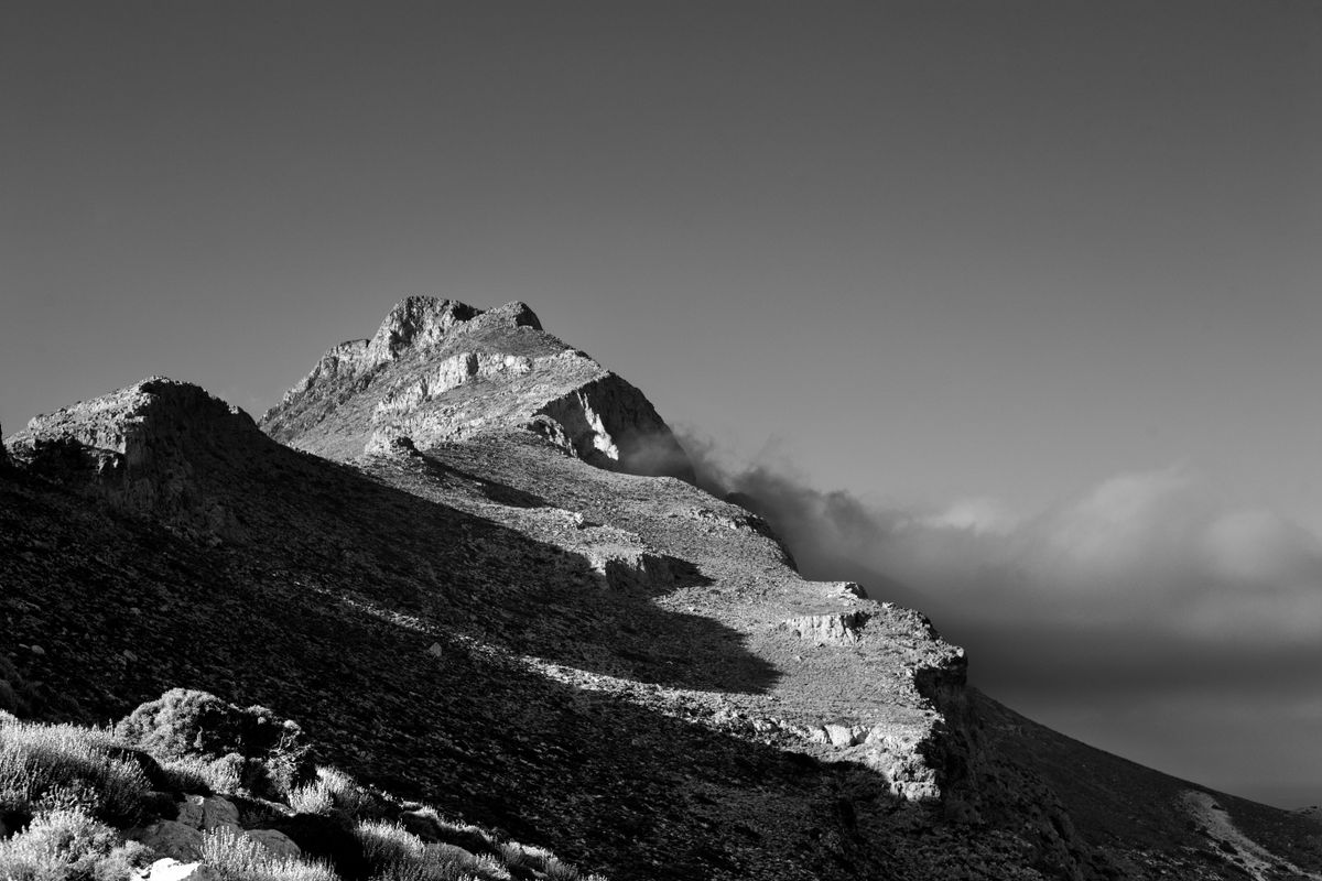 Black and white photo of Mount Ida's rugged terrain in Greece with dramatic shadows.