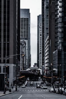 A striking city scene featuring towering skyscrapers and a bustling street.