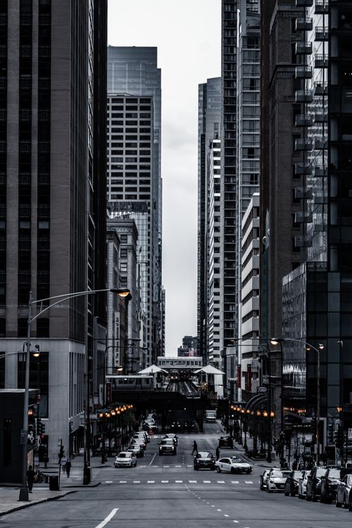 Free A striking city scene featuring towering skyscrapers and a bustling street. Stock Photo