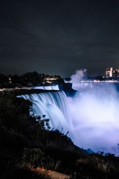 Illuminated Niagara Falls cascading at night, a breathtaking natural wonder.
