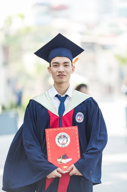 Free Man In Toga Holding Diploma Stock Photo