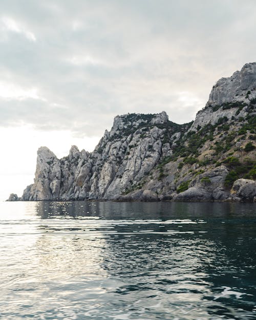 Gray Rocky Mountain Beside Body of Water