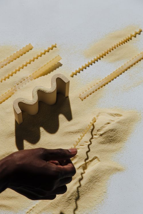 Free Creative overhead view of pasta making with shadows and flour. Stock Photo