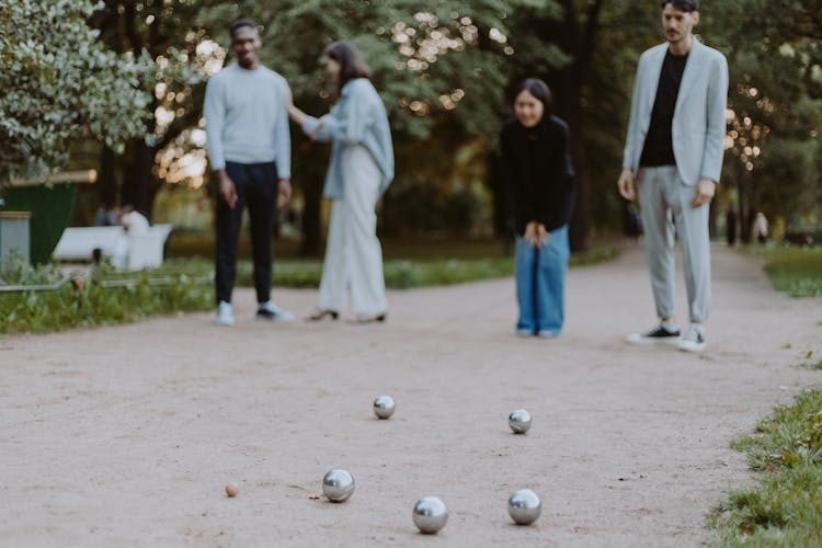 A Man And A Woman Playing Balls On Sand