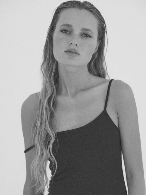 Monochrome Photo of a Woman in a Tank Top Looking at the Camera