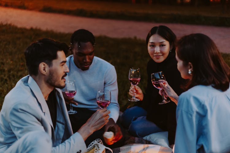 A Group Of People Drinking Wine