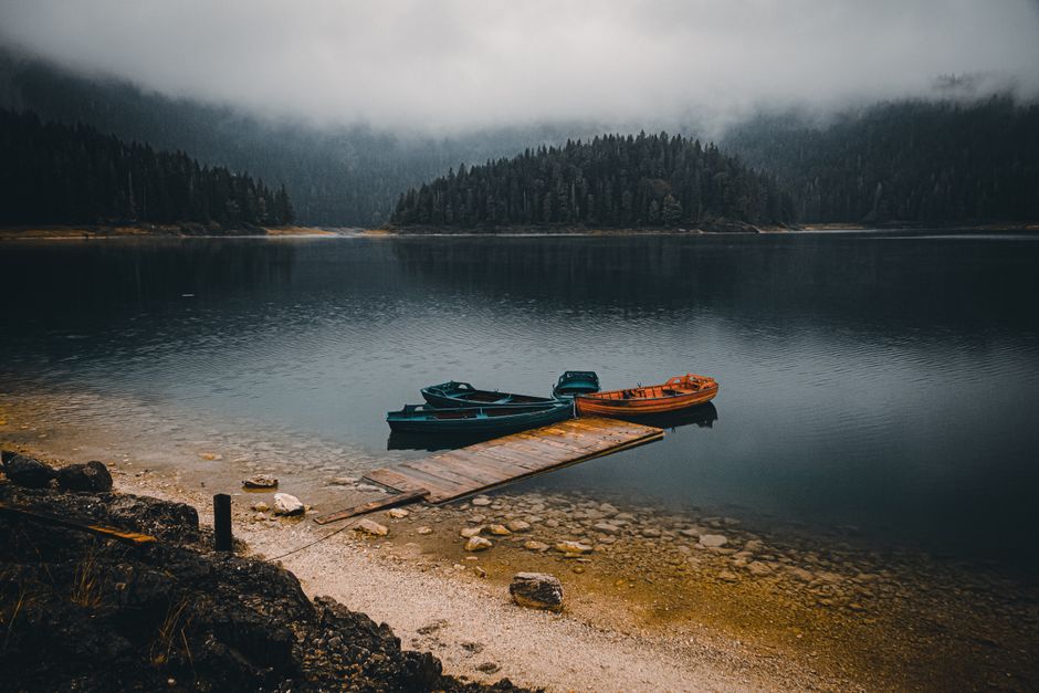 Hikers enjoying the serene Black Lake in Durmitor National Park, Montenegro.