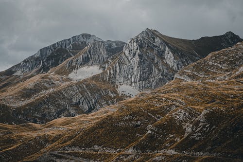 Brown and Gray Rocky Mountains under Gray Sky