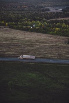 A lone truck travels through the scenic countryside road in Николаевка, Башкортостан, Russia.