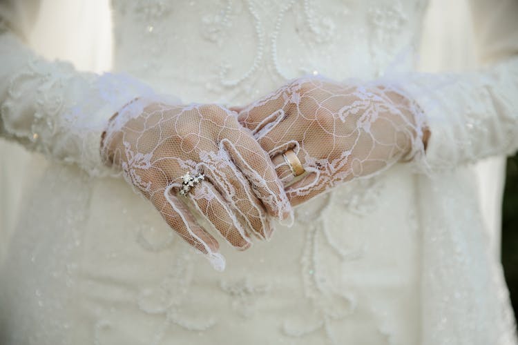 Close Up On Womans Hands In Wedding Gloves