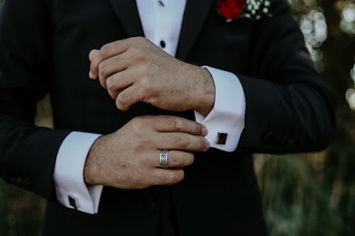 Close up on Mans Hands in Wedding Suit