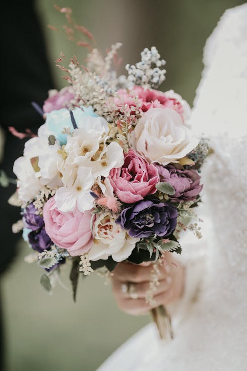 Close up on Bouquet in womans Hands Dressed for Wedding