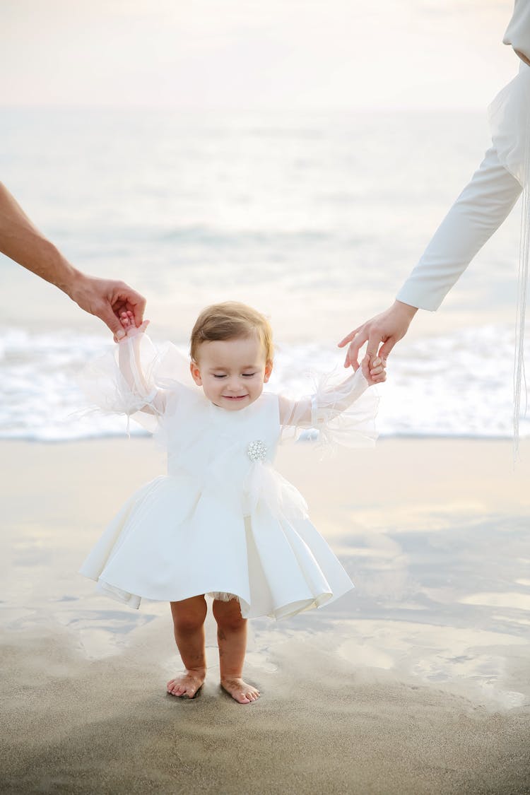 Close Up On Child Being Held By Parents