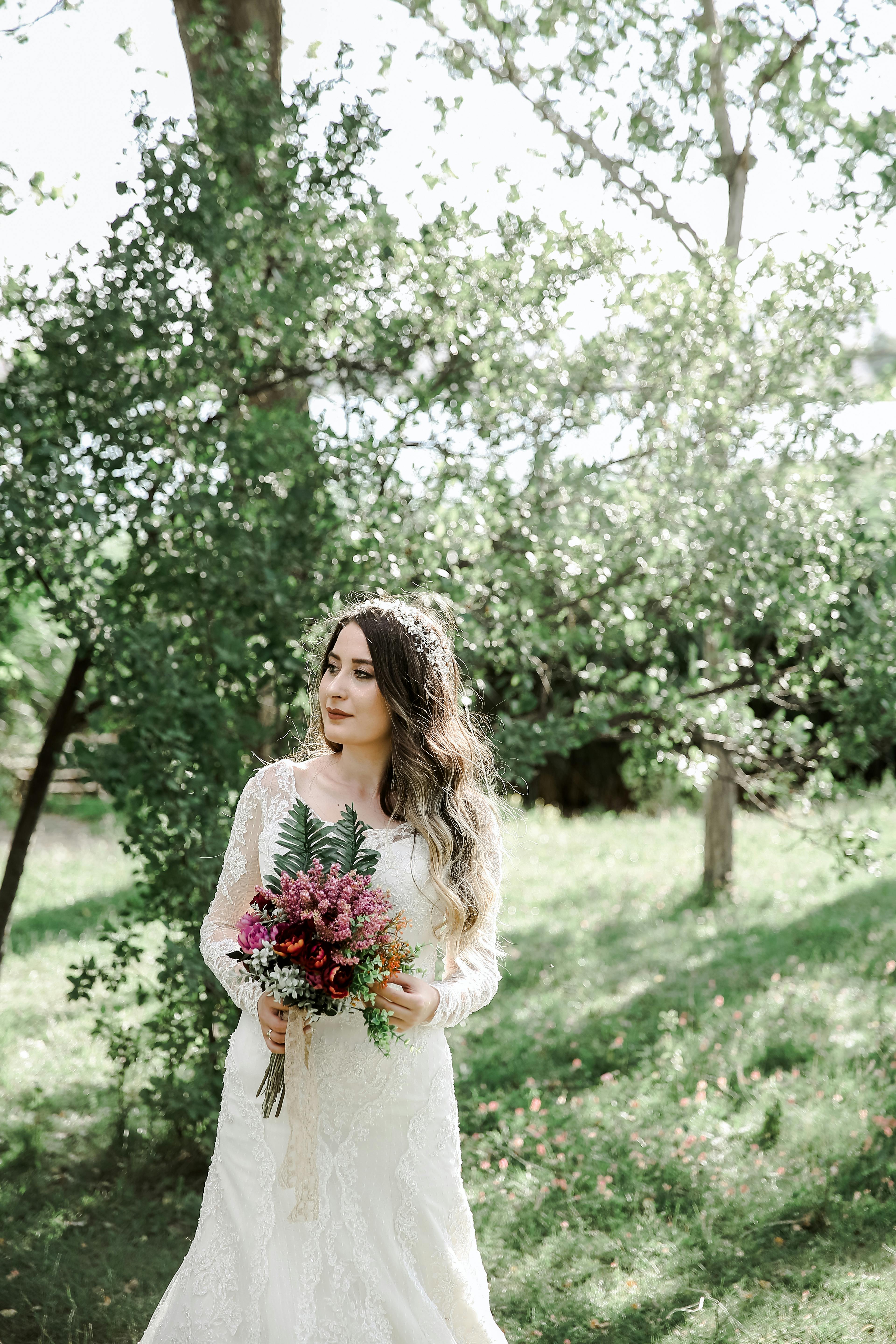 Redhead Woman in a Wedding Dress Posing by a Waterfall · Free Stock Photo