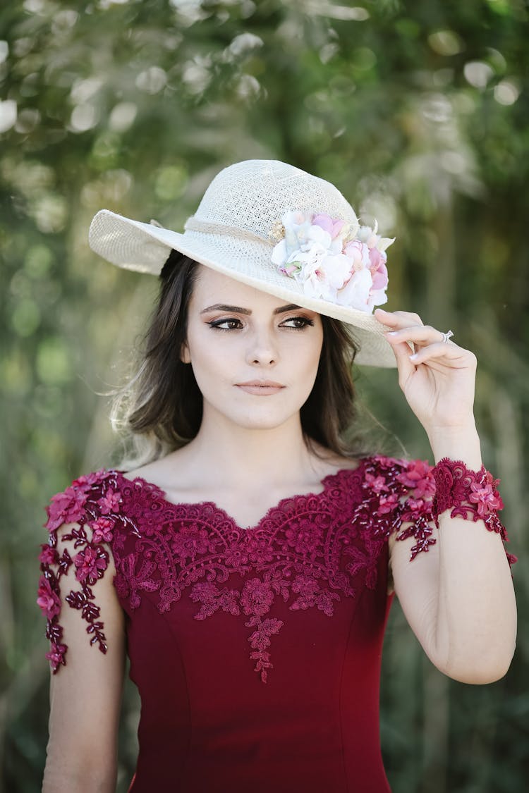 Woman In Red Dress With Embroidery And Hat With Flowers