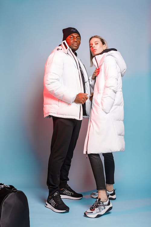 Man and Woman Wearing White Winter Coats 