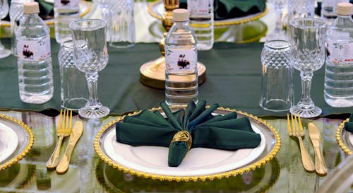 Free Table Setting with Golden Plate and Silverware Stock Photo