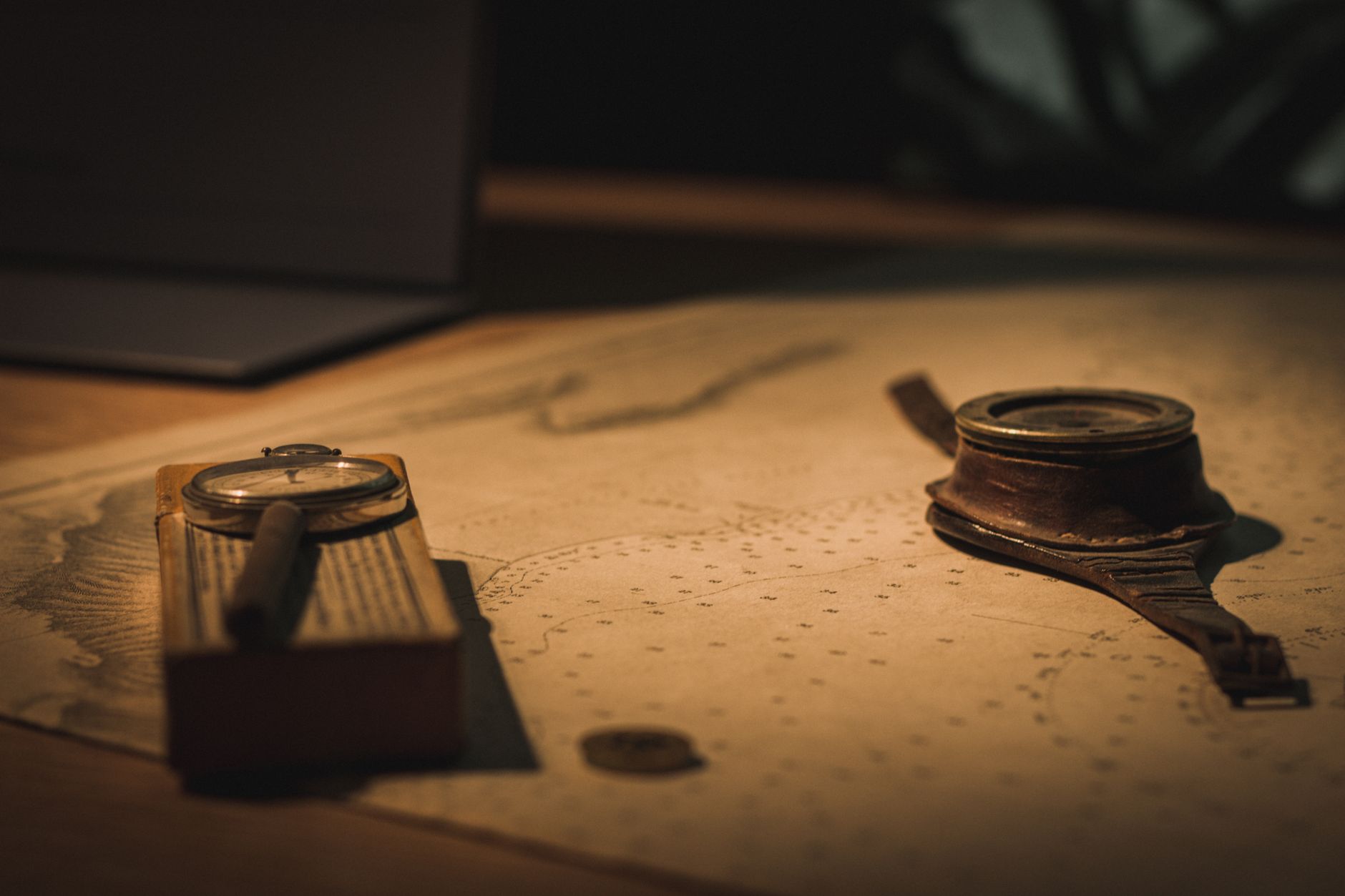 compass resting on an open navigation map