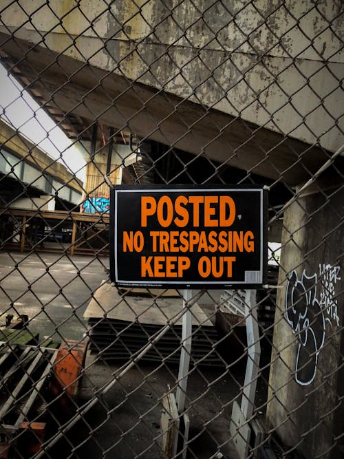 A Signage Hanging on a Chain Link Fence