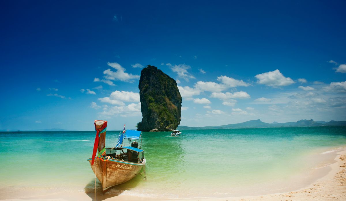 Sunny tropical beach with families enjoying the shore