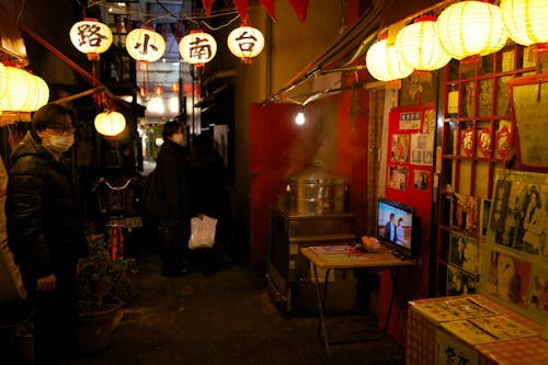  A Person Standing at a Restaurant in an Alley