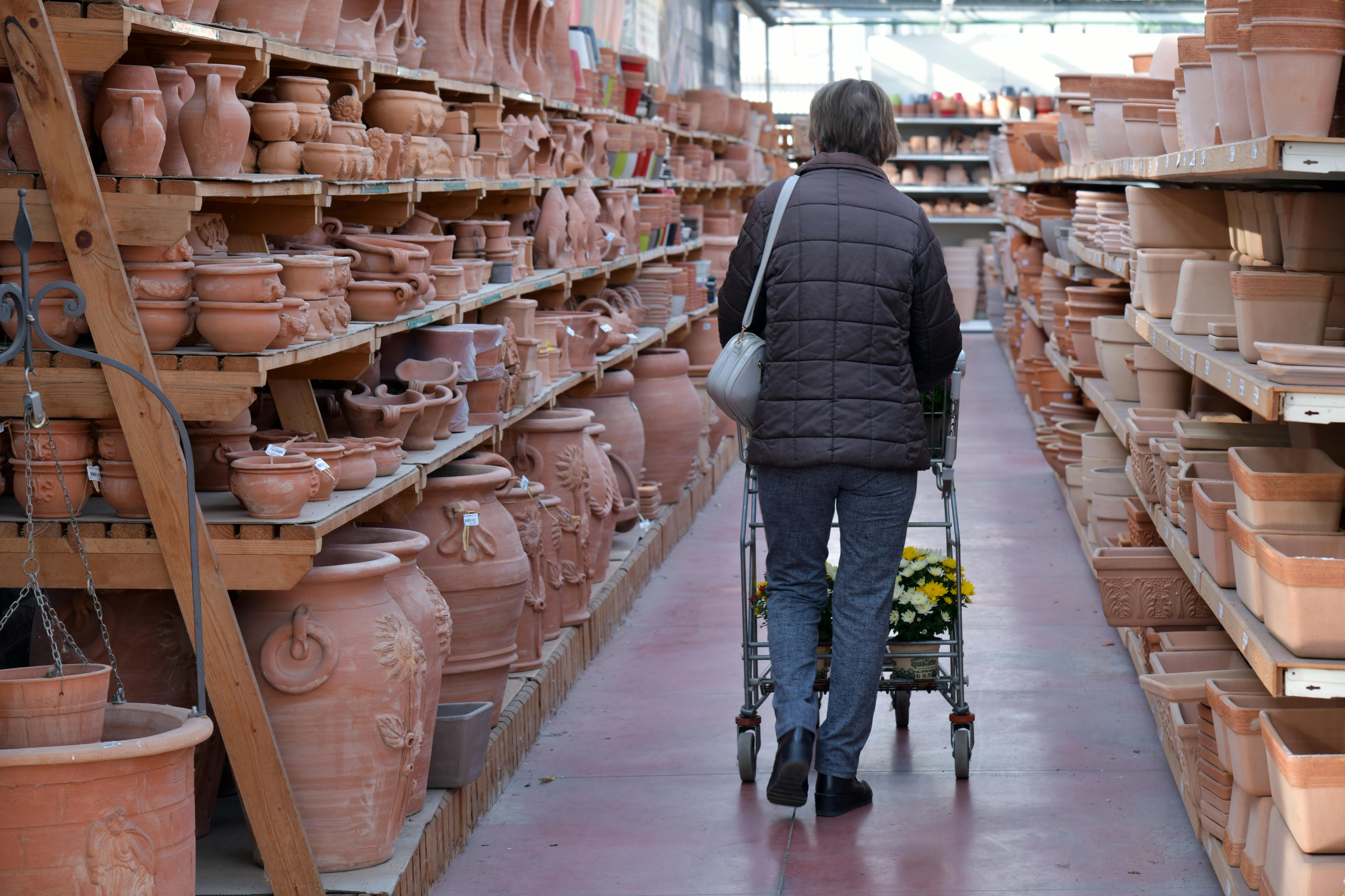 back view of a woman looking at ceramic products in a store