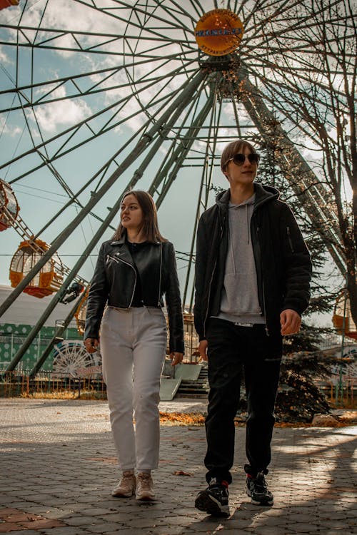 A Young Man and Woman Waking at an Amusement Park