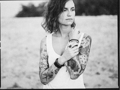 Grayscale Photo of a Tattooed Woman