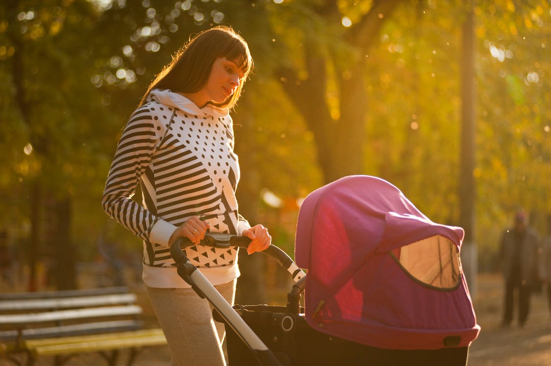 Woman Holding Pink And Black Stroller