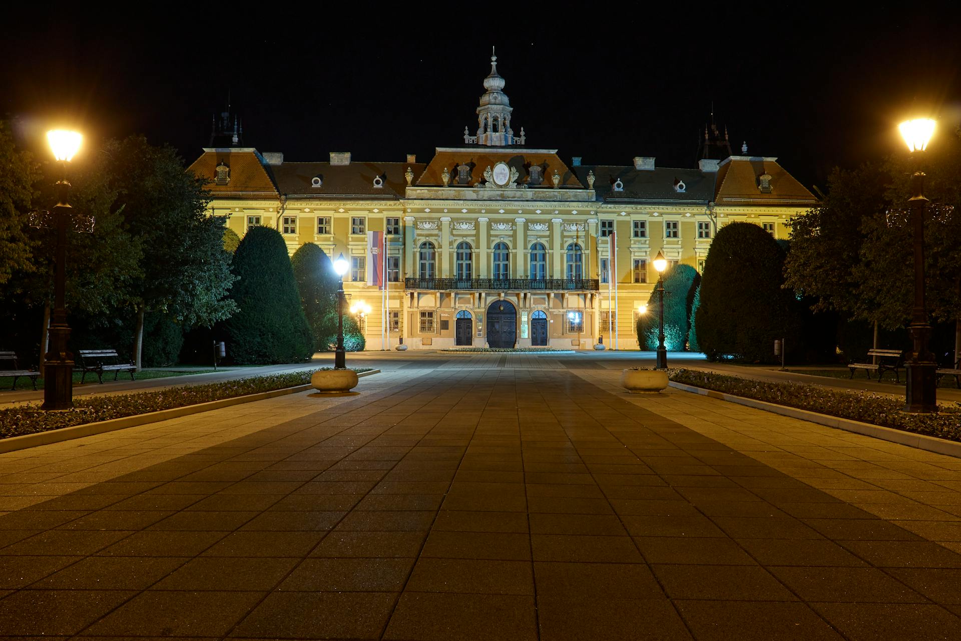 Elegant night view of Sombor City Hall in Serbia with warm lights.