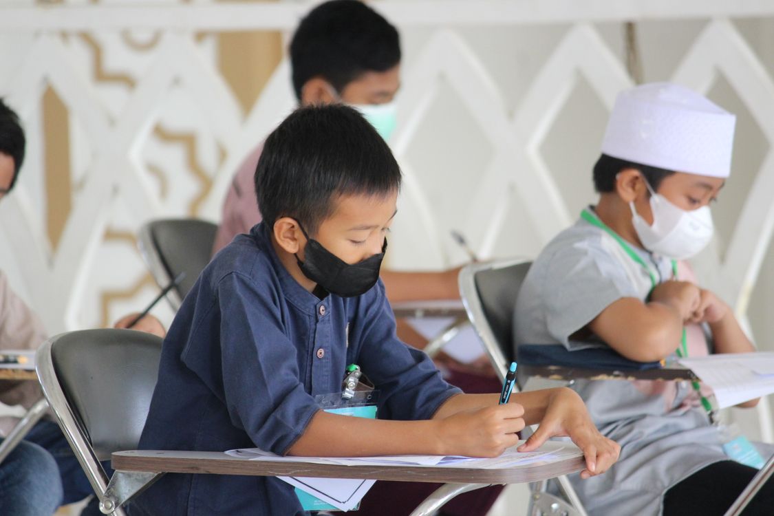 Students Using Paper Young Student writing on Paper · Free Stock Photo