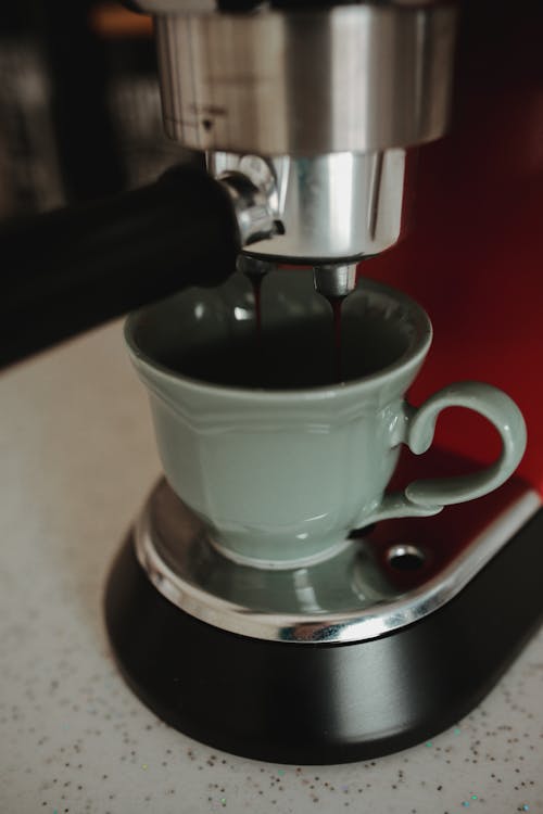 Free Green Ceramic Cup Being Filled With Coffee Stock Photo