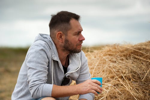 Fotografía De Enfoque Superficial Del Hombre Con Capucha Gris