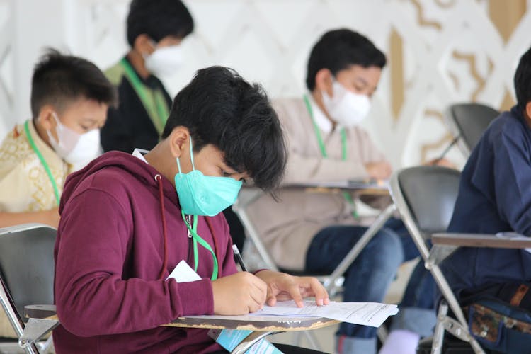 Boys Writing On Tables