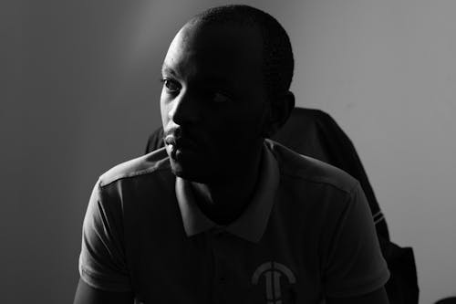 A Grayscale Photo of a Man Wearing Polo Shirt