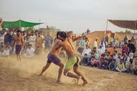 Live kushti match with audience in Sillanwali, Punjab. Traditional sport event.