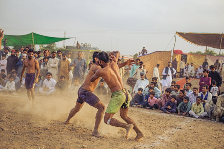 Men Fighting On A Battle With People Watching 