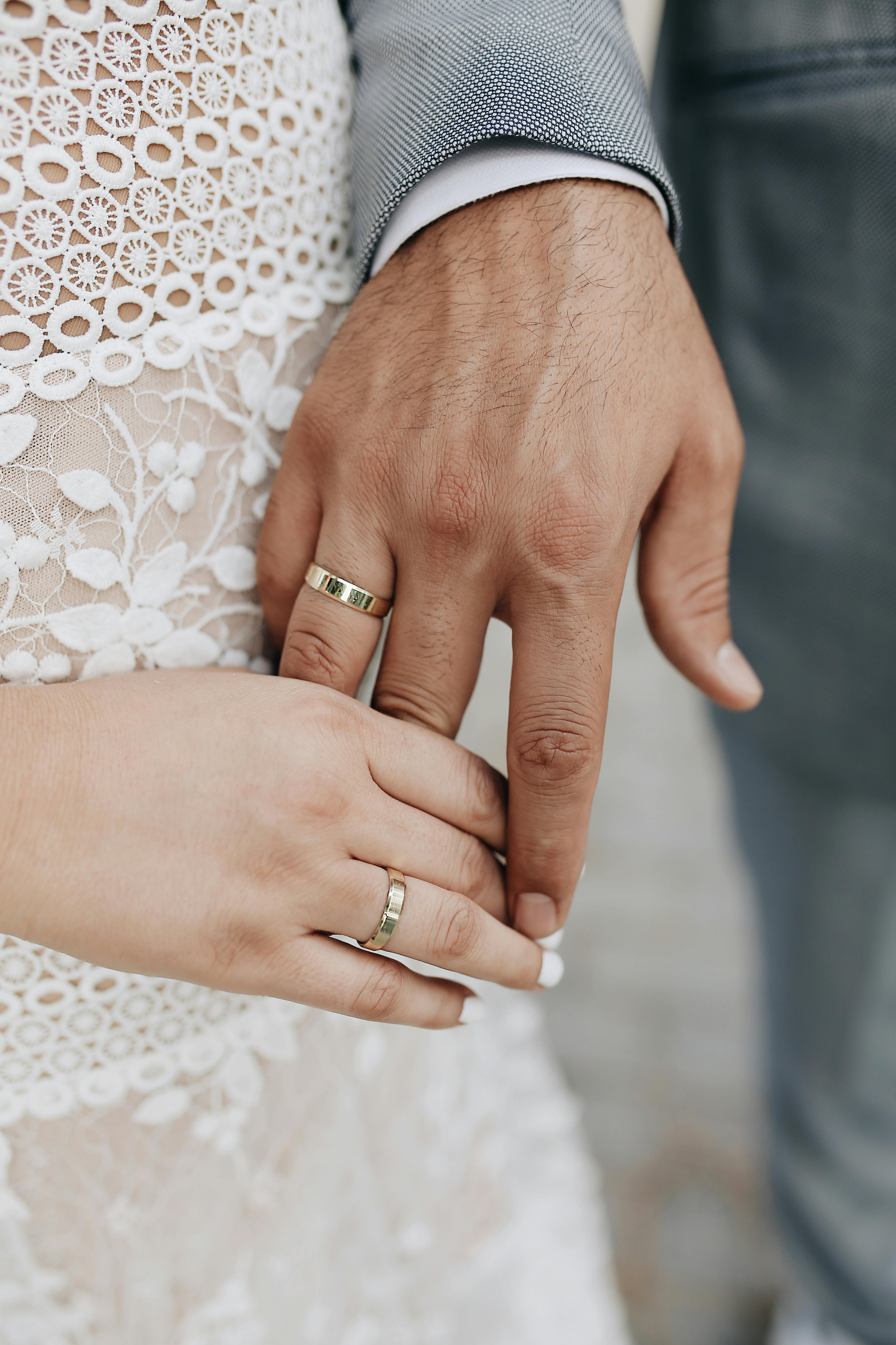 hands of newlywed with rings