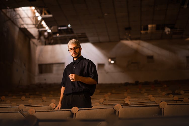 Man In Shirt Among Seats