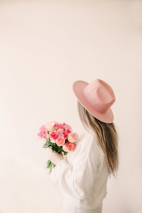 Woman in Pink Hat Holding Bouquet