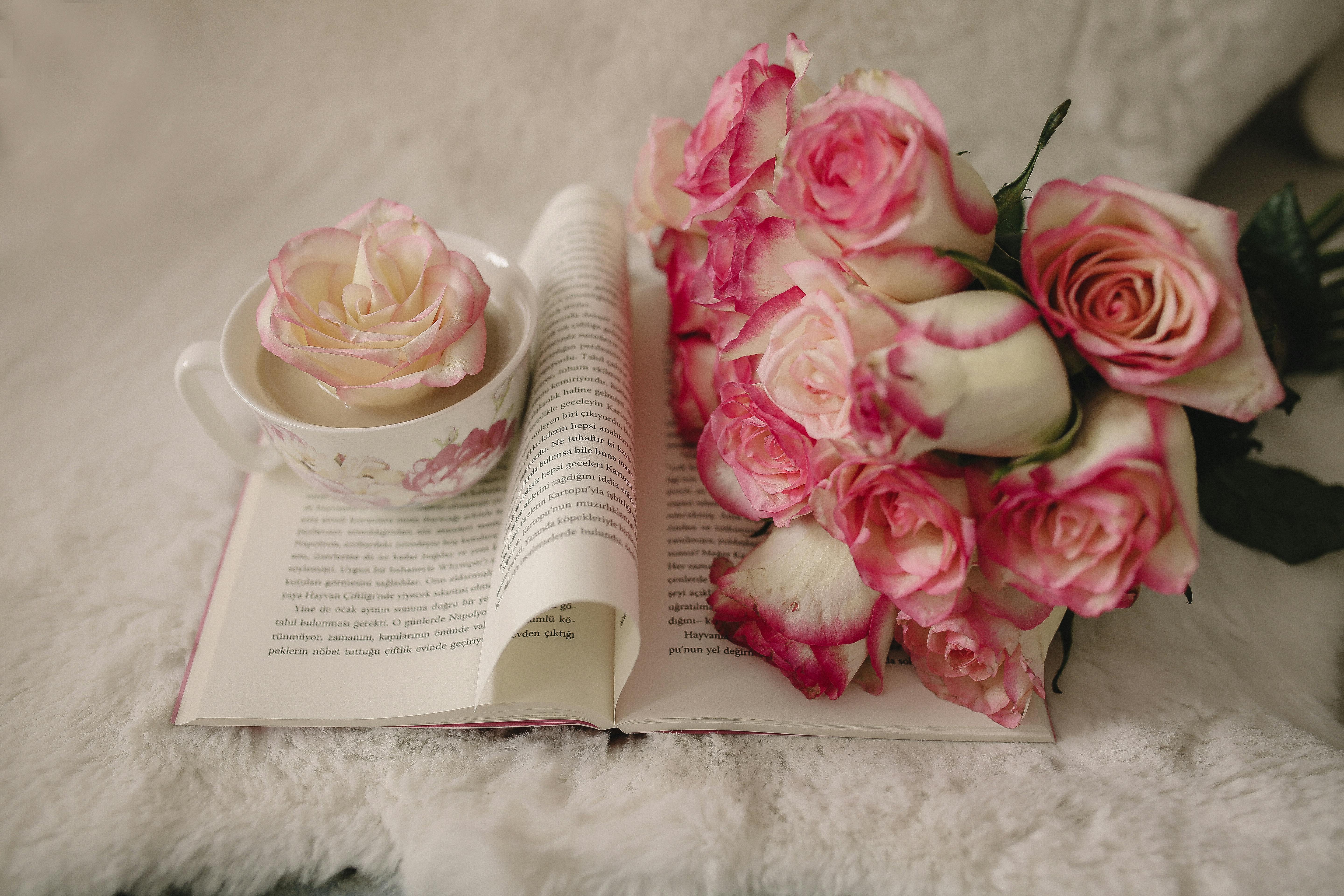 flowers on book and in cup